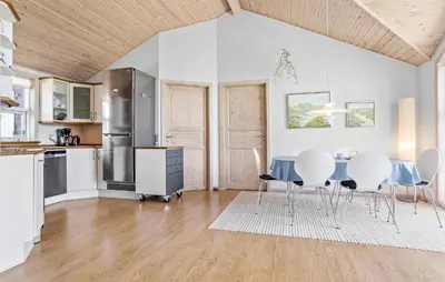 a kitchen and dining room with a table and chairs at 3 Bedroom Amazing Home In Vestervig in Vestervig