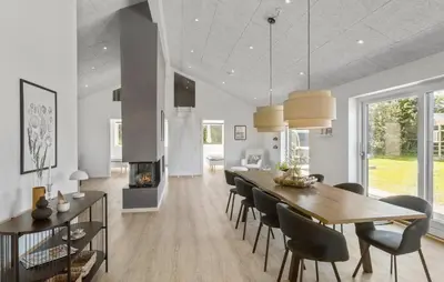 a dining room with a table and chairs and a fireplace at Gorgeous Home In Saltum With Sauna in Saltum