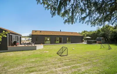 a yard with two metal sculptures in the grass at Gorgeous Home In Saltum With Sauna in Saltum