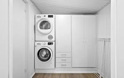 a laundry room with a washer and a dryer at 2 Bedroom Awesome Home In Højslev in Højslev