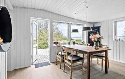 a kitchen and dining room with a table and chairs at 2 Bedroom Awesome Home In Højslev in Højslev