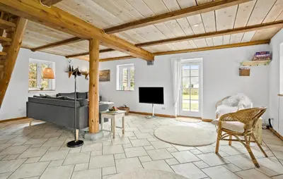 a living room with a couch and a television at 4 Bedroom Cozy Home In Vestervig in Vestervig