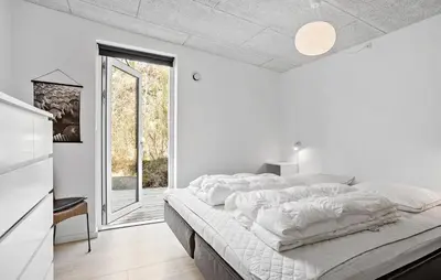 a white bedroom with a large bed and a window at Stunning Home In Roslev With Kitchen in Roslev