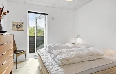 a white bedroom with a large bed and a window at Stunning Home In Roslev With Kitchen in Roslev