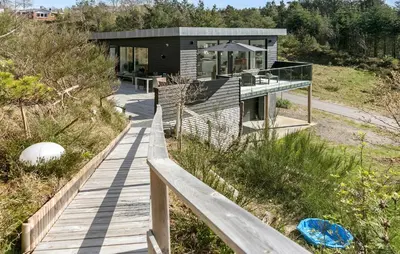 a house on a hill with a wooden walkway at Stunning Home In Roslev With Kitchen in Roslev