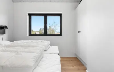 a row of white beds in a room with a window at Stunning Home In Saltum With Sauna in Saltum