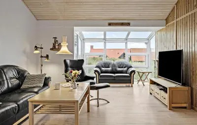 a living room with leather furniture and a flat screen tv at Gorgeous Home In Thisted in Thisted