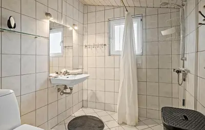 a white bathroom with a sink and a shower at Gorgeous Home In Thisted in Thisted