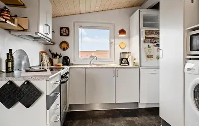 a kitchen with white cabinets and a window at Gorgeous Home In Thisted in Thisted