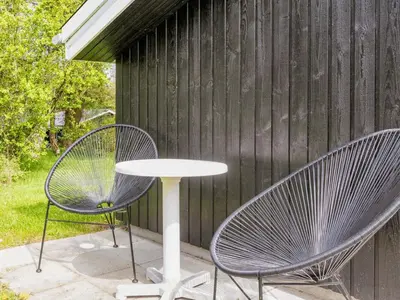 two chairs and a table on a patio at 6 person holiday home in Farsø-By Traum in Farsø