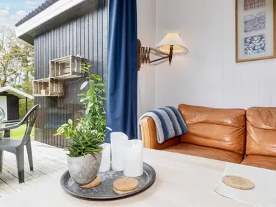 a living room with a couch and a table at 6 person holiday home in Farsø-By Traum in Farsø