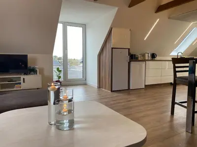 a living room with a table with candles on it at Sunny apartment in Åbybro