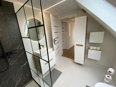 a bathroom with a sink and a mirror at Sunny apartment in Åbybro