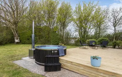 a hot tub sitting on a wooden deck at 3 Bedroom Beautiful Home In Vesløs in Vesløs