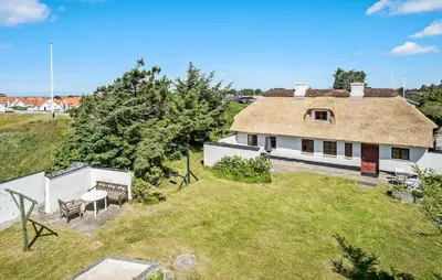 an aerial view of a house with a roof at 4 Bedroom Nice Home In Blokhus in Blokhus