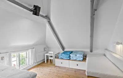 a white room with a bed and a window at 4 Bedroom Nice Home In Blokhus in Blokhus