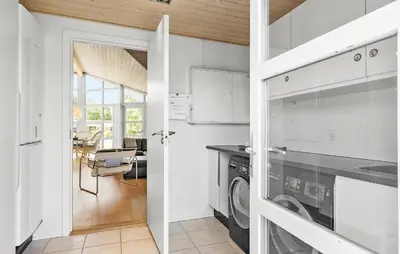 a kitchen with a washer and dryer in a room at Pet Friendly Home In Farsø With Wifi in Farsø