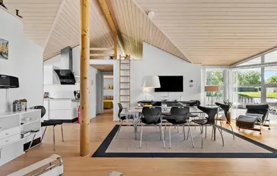 a dining room and living room with a table and chairs at Pet Friendly Home In Farsø With Wifi in Farsø