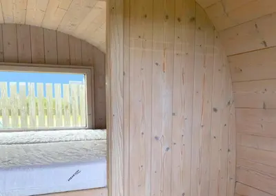 a room with a window and a wooden wall at Camping Vesterhav in Harboør