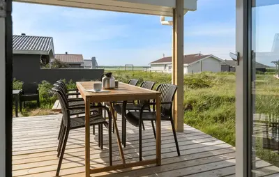 a wooden table and chairs on a deck at Stunning Home In Harboøre With Wifi in Harboør