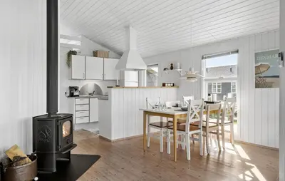 a kitchen and dining room with a wood stove at Stunning Home In Harboøre With Wifi in Harboør