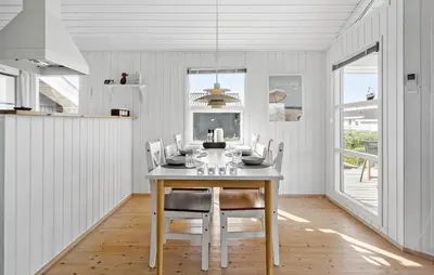a white dining room with a table and chairs at Stunning Home In Harboøre With Wifi in Harboør