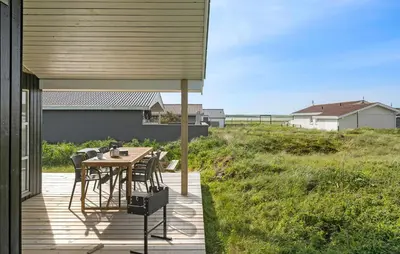 a wooden deck with a table and chairs at Stunning Home In Harboøre With Wifi in Harboør