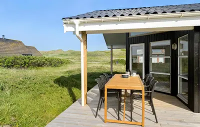 a patio with a wooden table and chairs at Stunning Home In Harboøre With Wifi in Harboør
