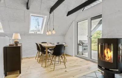a living room with a table and chairs and a fireplace at Beautiful Home In Spøttrup With Kitchen in Spottrup