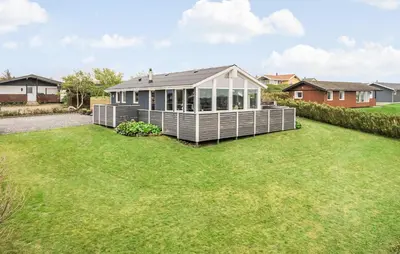 a house with a greenhouse on a lawn at Nice Home In Lemvig With Wifi in Lemvig