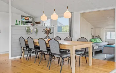 a dining room with a wooden table and chairs at Nice Home In Lemvig With Wifi in Lemvig