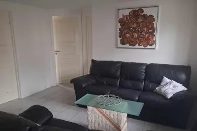a living room with a black couch and a table at Marku House in Struer