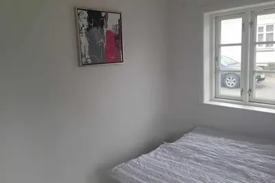 a bedroom with a bed next to a window at Marku House in Struer