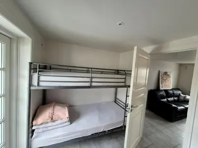 a room with two bunk beds and a couch at Marku House in Struer