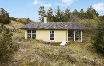 a small yellow house sitting on top of a hill at 2 Bedroom Nice Home In Fjerritslev in Fjerritslev