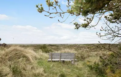 a bench sitting in the middle of a field at 2 Bedroom Nice Home In Fjerritslev in Fjerritslev