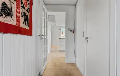 a hallway with white walls and a door with a painting at 2 Bedroom Nice Home In Fjerritslev in Fjerritslev