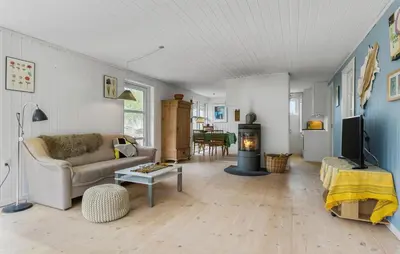 a living room with a couch and a fireplace at 2 Bedroom Nice Home In Fjerritslev in Fjerritslev