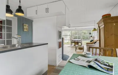 a kitchen with a sink and a table with a book at 2 Bedroom Nice Home In Fjerritslev in Fjerritslev