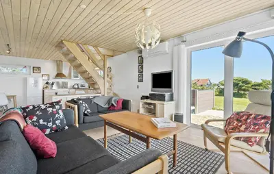 a living room with a couch and a table at Gorgeous Home In Øster Assels With Wifi in Øster Assels