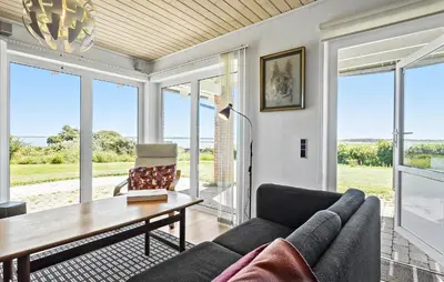 a living room with a couch and a table at Gorgeous Home In Øster Assels With Wifi in Øster Assels