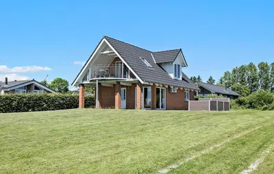 a house on a hill with a large yard at Gorgeous Home In Øster Assels With Wifi in Øster Assels
