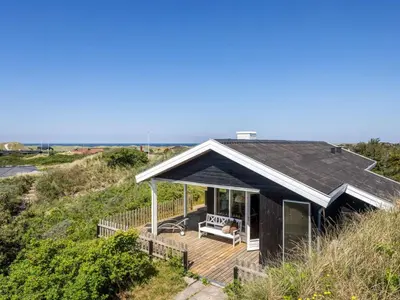 a house on the beach with a deck at Holiday Home Letje - 500m from the sea by Interhome in Løkken