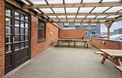 a patio with two picnic tables and a building at 11 Bedroom Gorgeous Home In Hurup Thy in Hurup