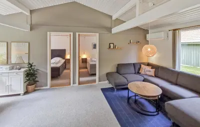 a living room with a couch and a table at Cozy Home In Spøttrup With Wifi in Spottrup
