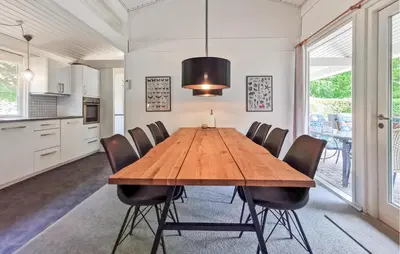a dining room with a wooden table and chairs at Cozy Home In Spøttrup With Wifi in Spottrup