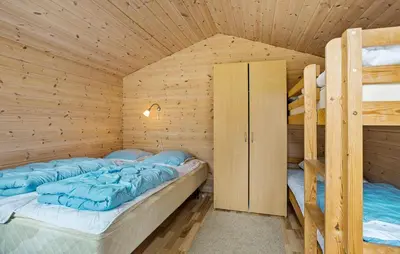 two bunk beds in a wooden cabin at Cozy Home In Spøttrup With Sauna in Spottrup