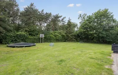a park with a trampoline in the grass at Cozy Home In Spøttrup With Sauna in Spottrup