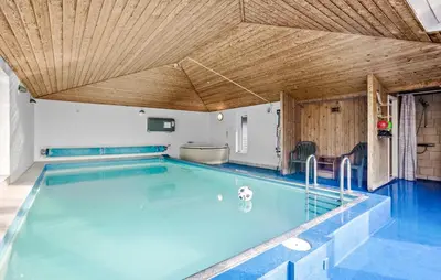 a large swimming pool with a wooden ceiling at Stunning Home In Vestervig With Sauna in Vestervig