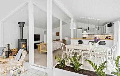 a dining room and living room with a table and chairs at 4 Bedroom Beautiful Home In Blokhus in Blokhus